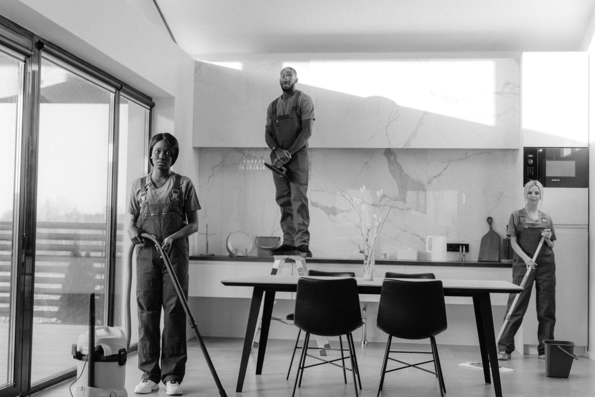 Professional cleaning team working in a bright dining area